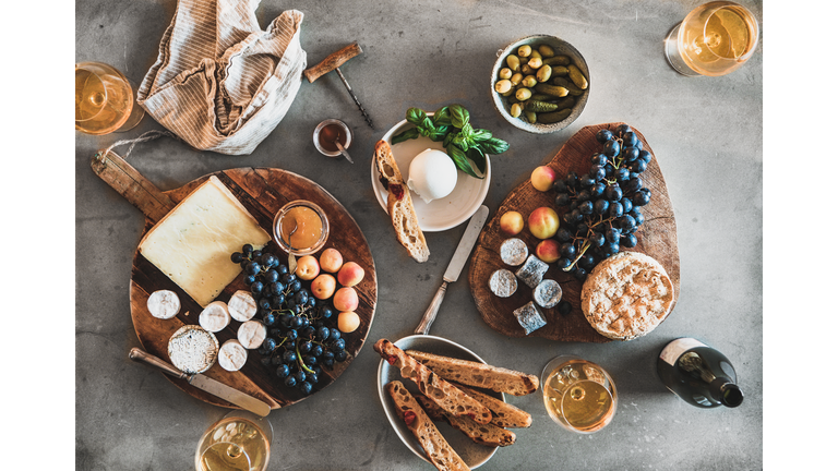 Flat-lay of wineglasses with rose or orange wine and snacks