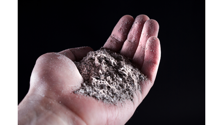 People hand holding gray ash