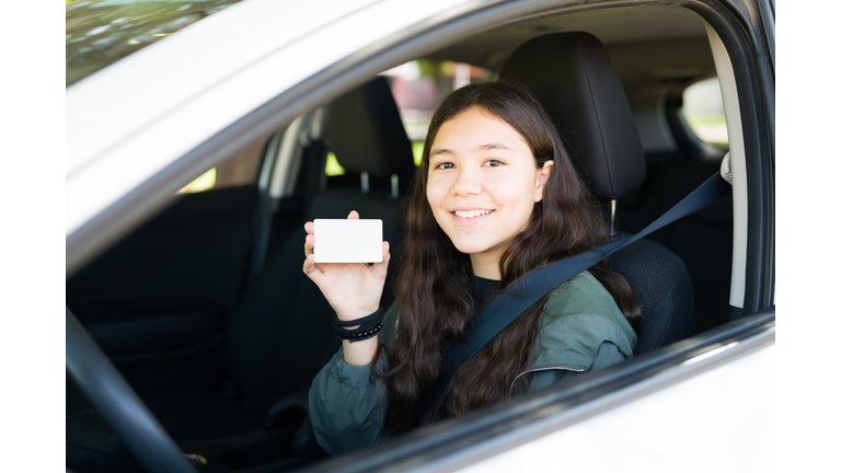 Cheerful teenage girl smiling after getting her driver's license