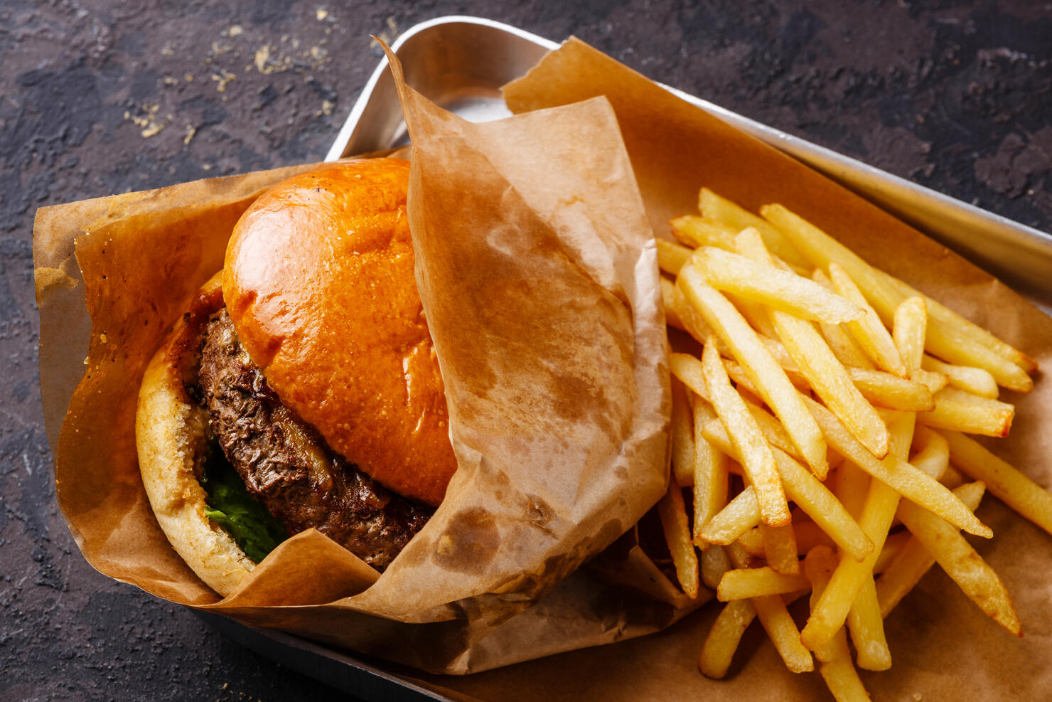 Burger and French fries in aluminum tray