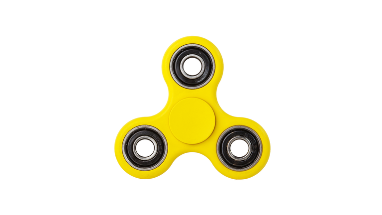 Close-Up Of Fidget Spinner Against White Background