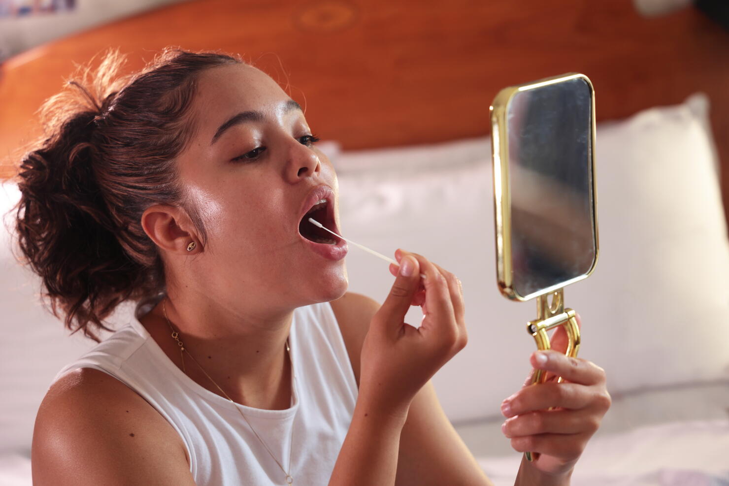 Woman taking sample from mouth