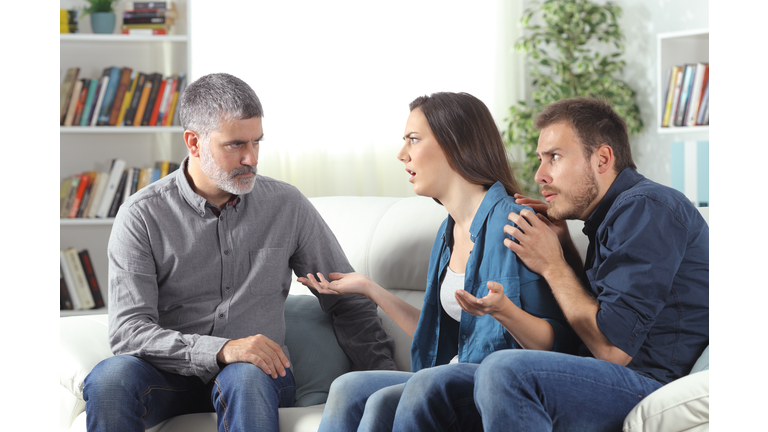 Angry father talking with daughter about scared boyfriend