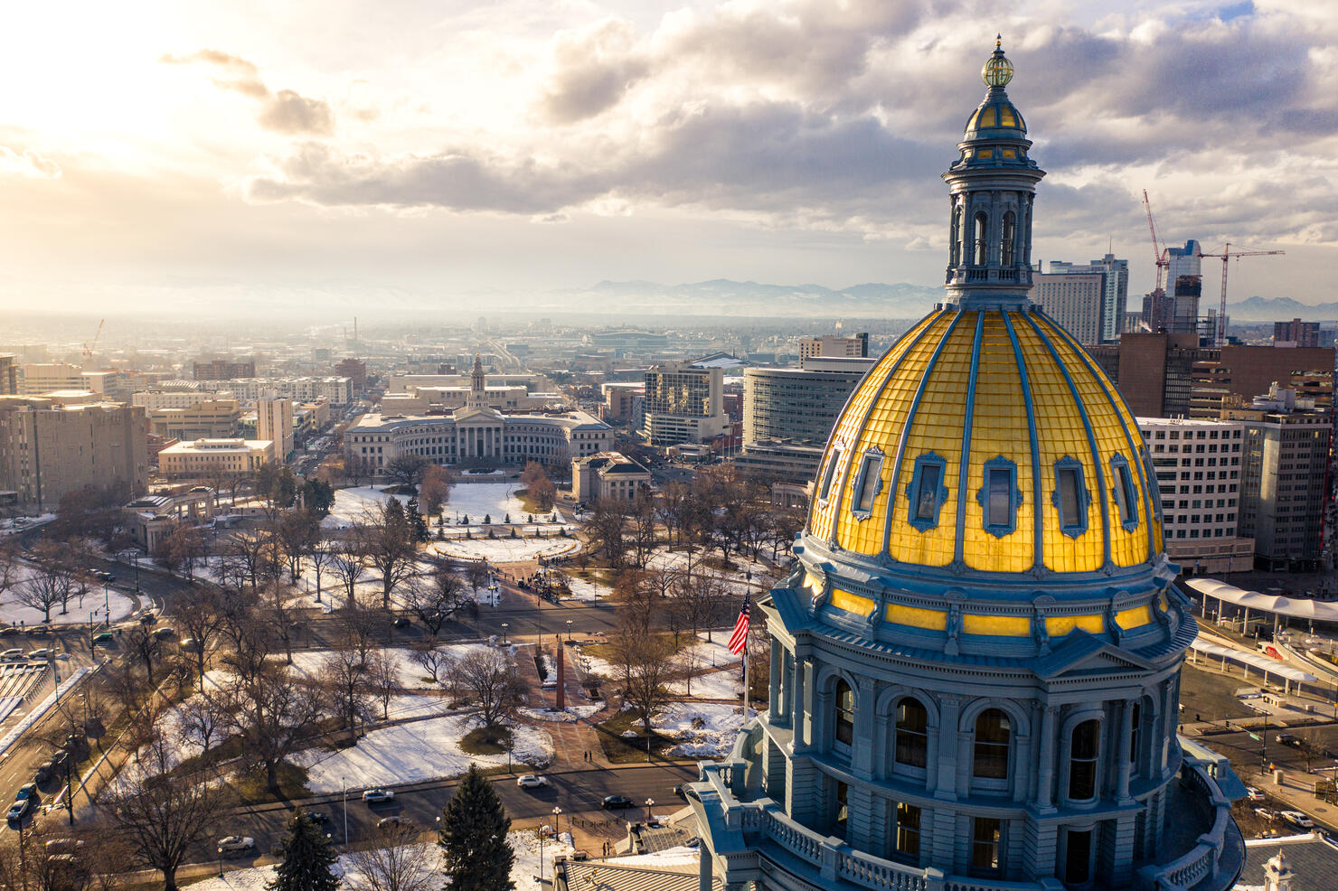 Colorado State Capitol Building & the City of Denver Colorado at Sunset.  Rocky Mountains on the Horizon