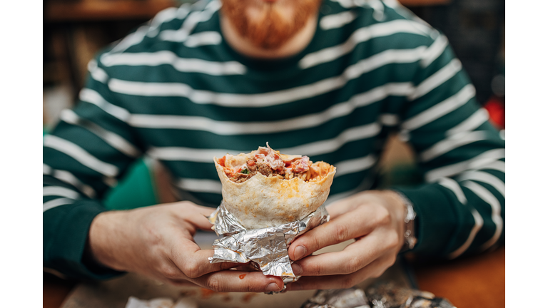 Man eating burritos