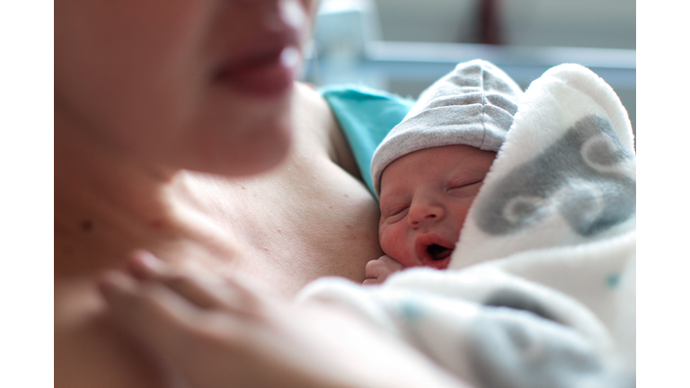 a Newborn baby boy breastfeeding for the first time.