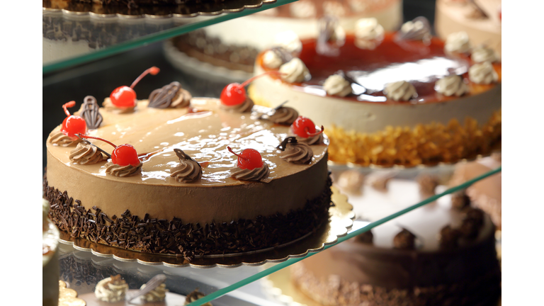 Different types of cakes in pastry shop glass display