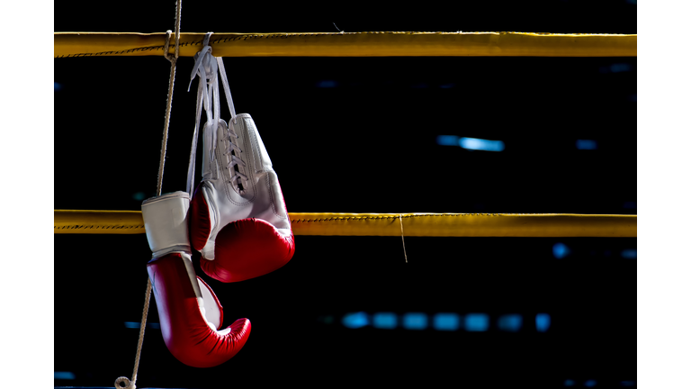 boxing gloves hangs off the boxing ring
