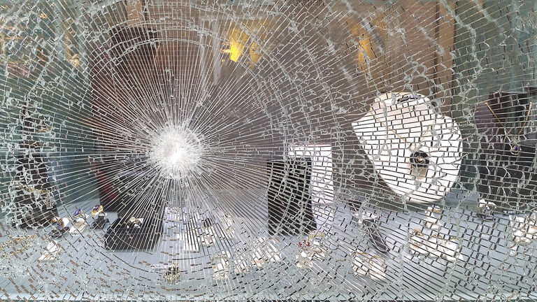 Broken window in jeweller's shop after raid