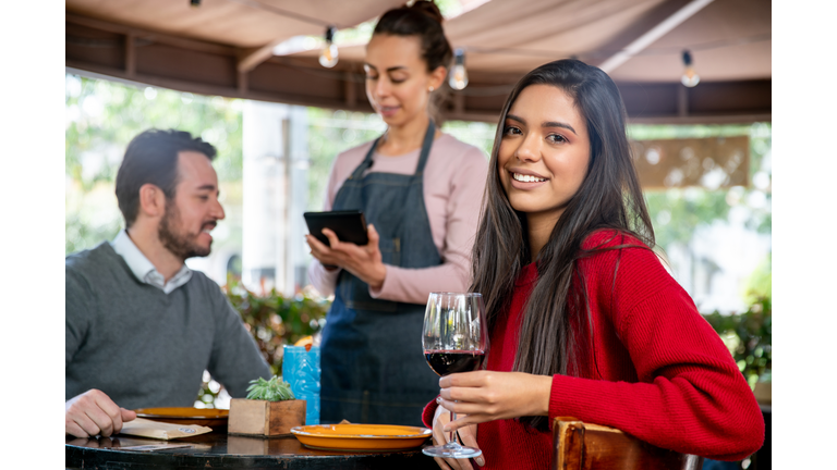 Woman on a date at a restaurant enjoying a glass of wine