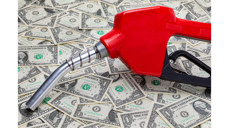 Gasoline fuel nozzle and cash money. Gas price, tax, ethanol and fossil fuel concept