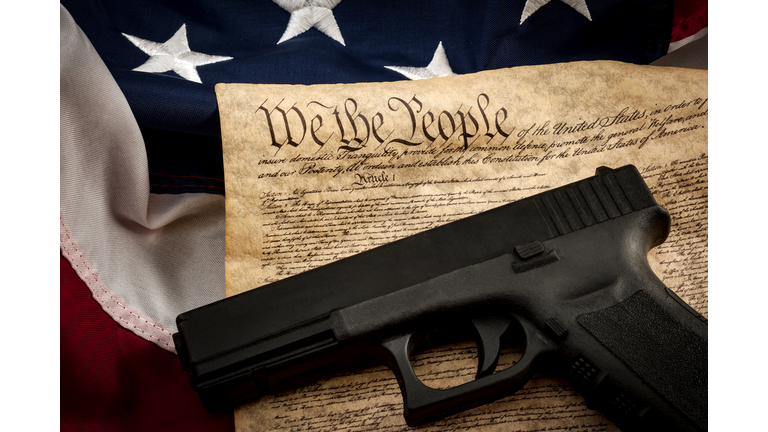 American constitution, USA flag and a handgun