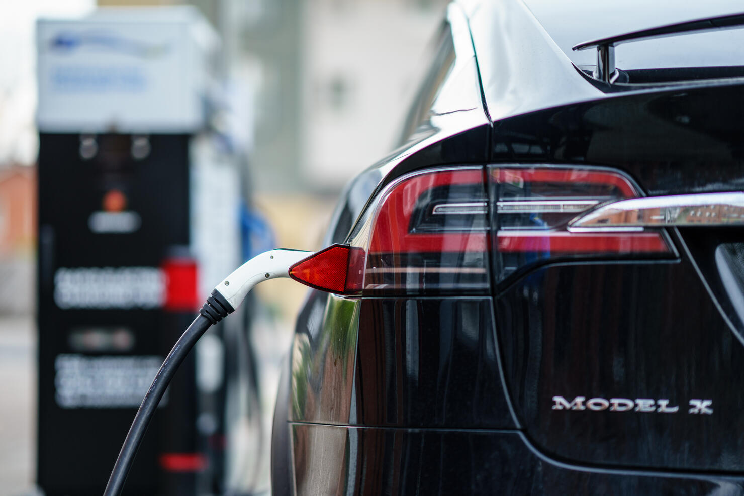 Electric Car Tesla Model X is charging on street charge station in UK.