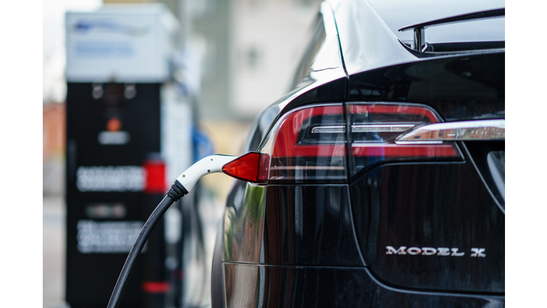 Electric Car Tesla Model X is charging on street charge station in UK.