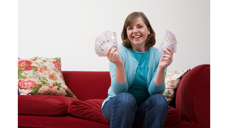 Smiling woman holding banknotes 