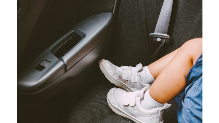 A toddler is sleeping in the car