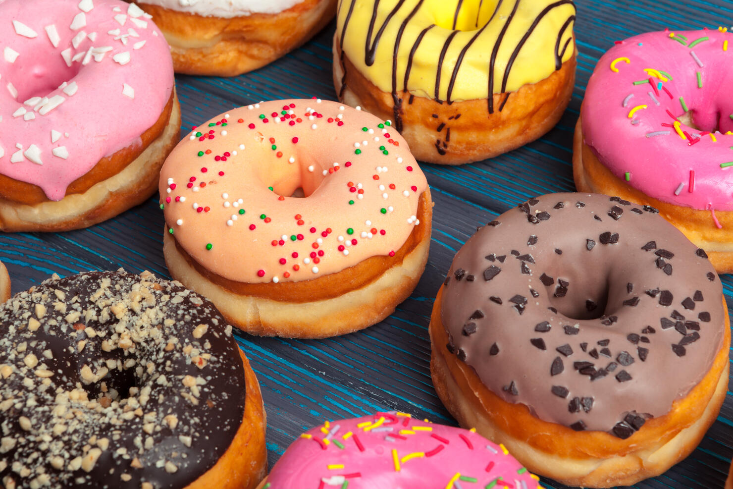 Colorful donuts assortment background top view close up