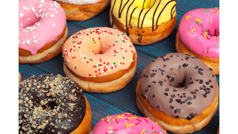 Colorful donuts assortment background top view close up