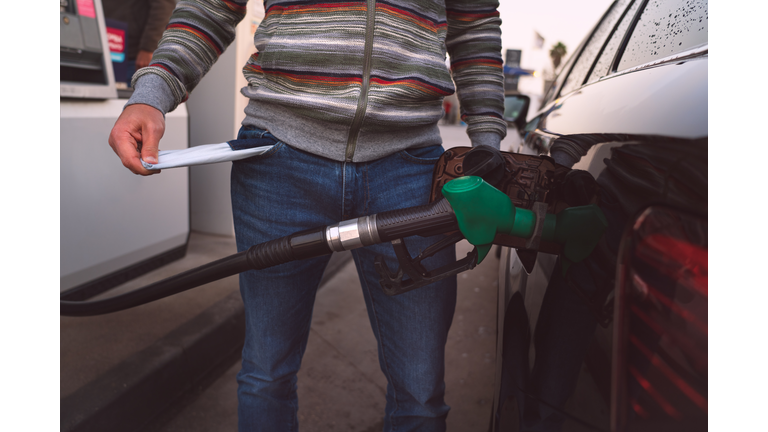 Man spend all his money on gasoline. Expensive gasoline. High petrol and fuel prices