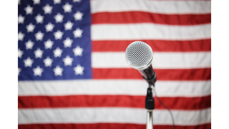 A microphone with an American flag in the background