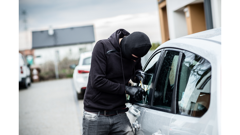 Car thief trying to break into a car