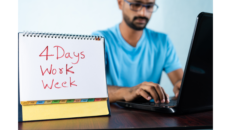 focus on calendar, Concept of four or 4 days work week showing by young man working in background and shows calendar