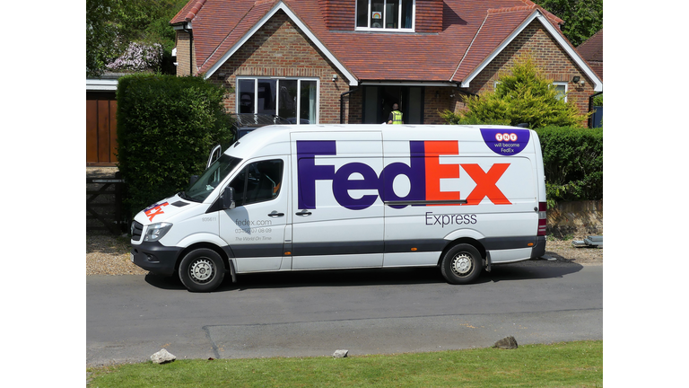 FedEx Express Mercedes-Benz Sprinter delivery van outside family house.