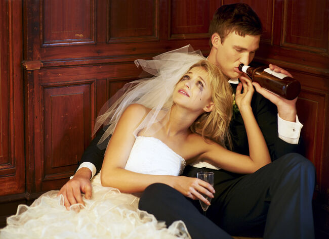 South Africa,Cape Town, Drunk bride and groom sitting on floor