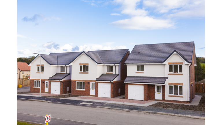 Row of new detached houses.