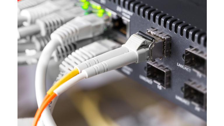 Close-up of high speed fiber network switch and cables in datacenter