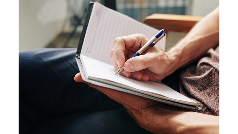 Man writing down thoughts