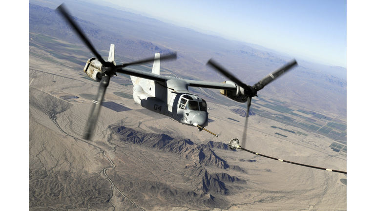 A Marine Corps MV-22 Osprey prepares to refuel midflight.