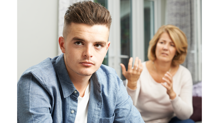 Bored Teenage Boy Being Told Off By Mother