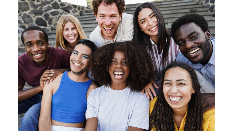 Young diverse people having fun outdoor laughing together - Diversity concept - Main focus on african girl face