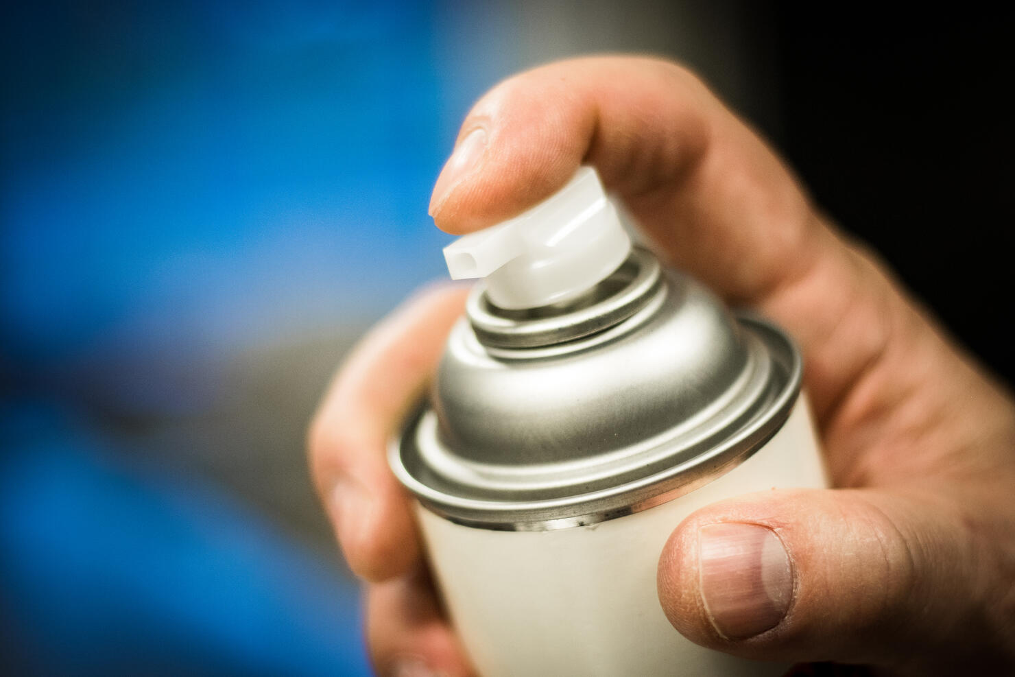 Aerosol spray can in hand ready to dispense.