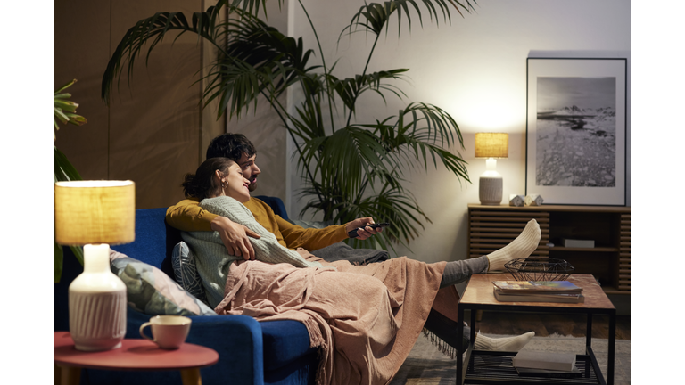 Mid Adult Couple Watching TV In Living Room