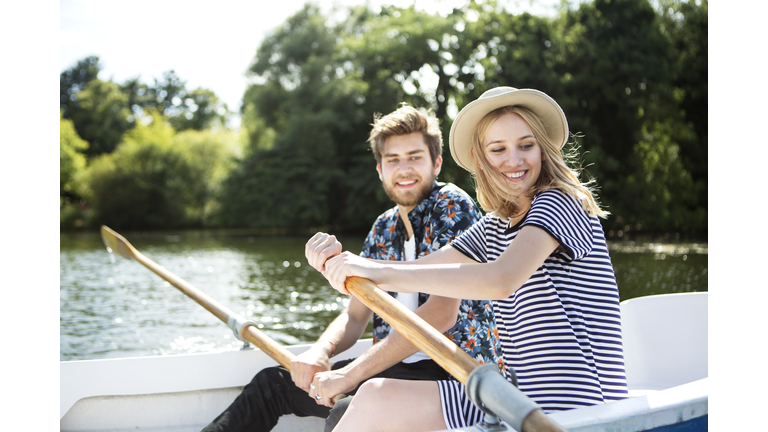 Couple rowing boat on lake