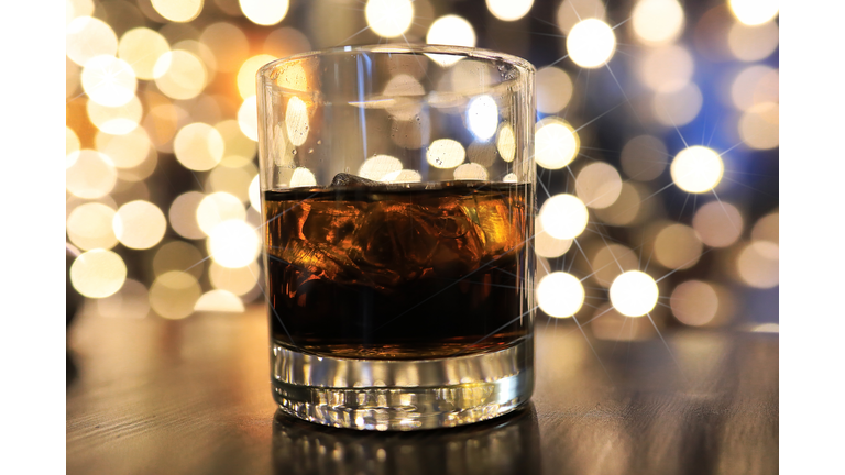 glass of cold alcohol drink with ice on table