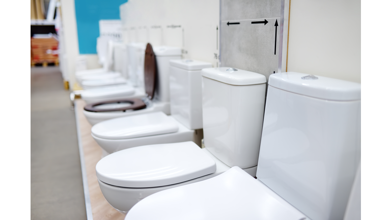 Variety toilets in construction store. Sanitary ware in hardware shop.