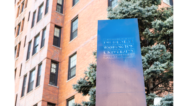 The George Washington University, GWU, campus, stella sign in District of Columbia against building, hall, dorm, dormitory in background with nobody, no people