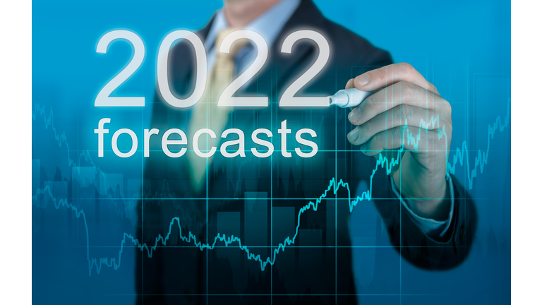 economic forecasts for 2022. businessman writes forecasts for 2022 on virtual screen. New Year 2022 forecasts. Businessman in suit forecast analysis plan profit chart with pen