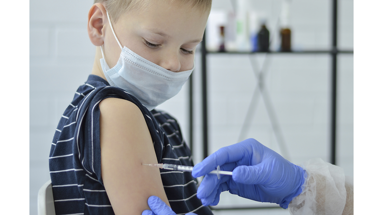 Close-up of pediatrician preparing a vaccine for a child during coronavirus pandemic. Injection, immunization, varriant omicron.