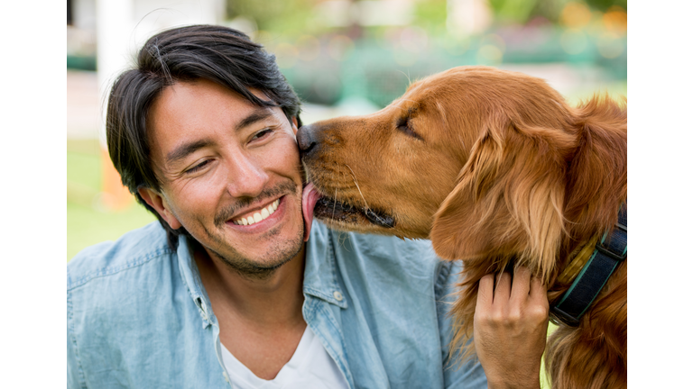 Dog licking a happy man