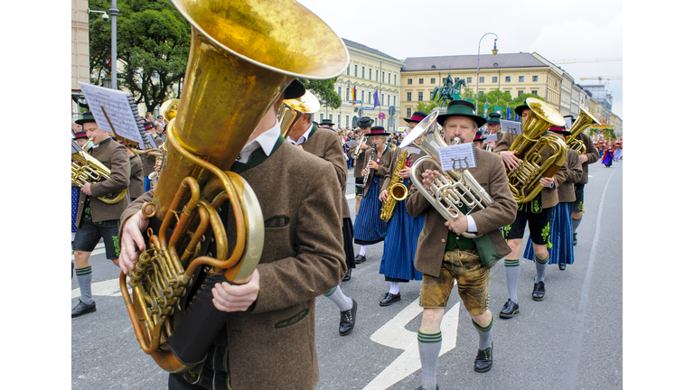 opening parade of the world-famous Oktoberfest in Munich with music band in historical and traditional costumes