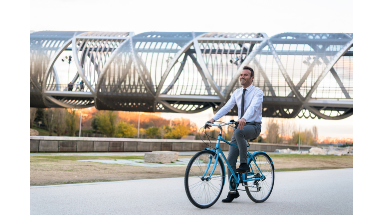 Business man riding a vintage bicycle in the city