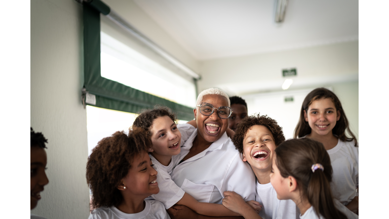 Portrait of  a happy group of elementary students with teacher