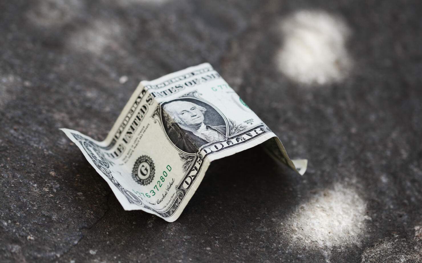 Dollar bill on concrete
