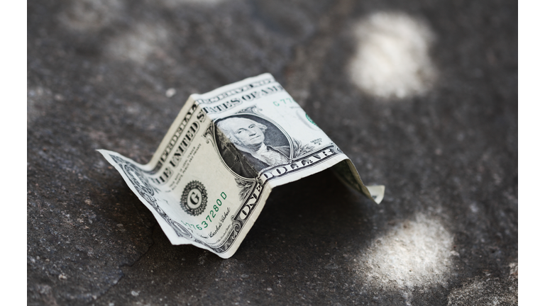 Dollar bill on concrete