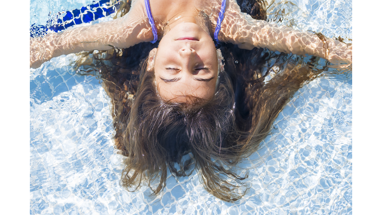 Beautiful girl relaxation to swimming pool