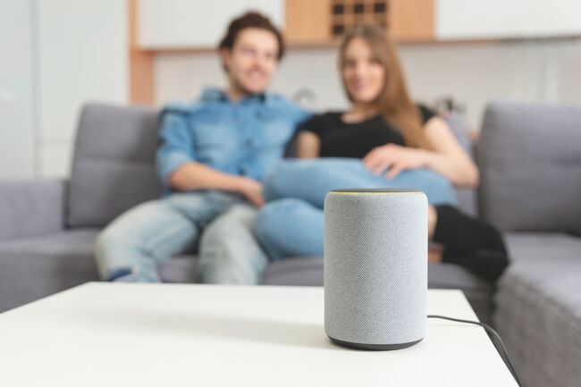 Couple talking command to smart speaker